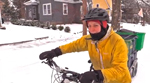 Person Pushing Bike in Snow